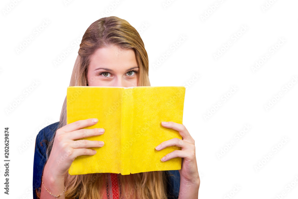 Poster student covering face with book in library against white background with vignette