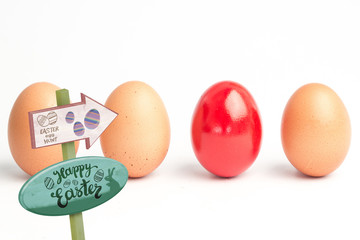 Easter egg hunt sign against four eggs in a row with one red one