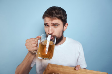 man with a beer and a tray in his hand