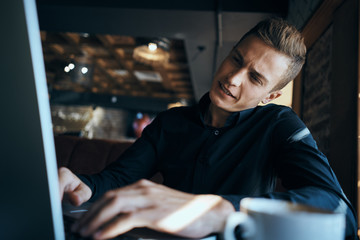 man with laptop tilted his head to the side