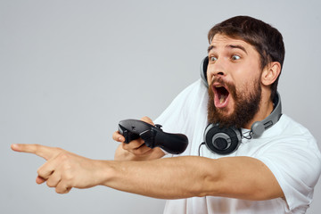 emotional man with a joystick and headphones around his neck