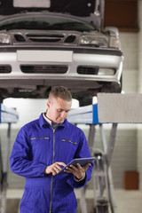 Mechanic touching a tablet computer