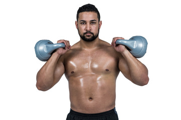 Fototapeta na wymiar Muscular man lifting heavy kettlebell 