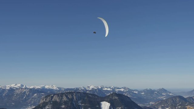 Paraglider flying above mountains 