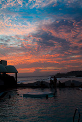 Sunset on the sea with people by the pool in Sri Lanka