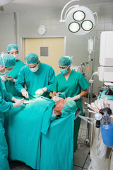 Surgeons and nurses around a patient
