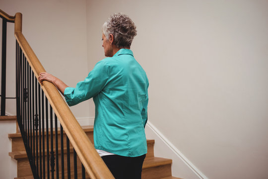 Senior Woman Walking Up Stairs