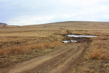 Fototapeta premium A country road in the steppe