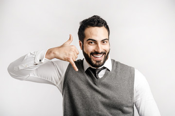 Bearded smiling businessman shows on isolated white background