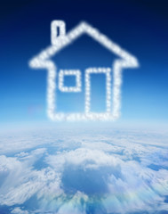Cloud in shape of house against blue sky over clouds at high altitude