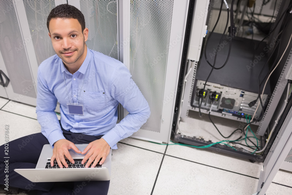 Poster Man smiling while doing server maintenance