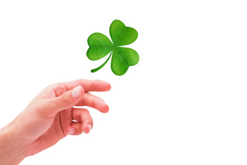 Shamrock against hand with raised fingers