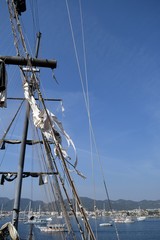 Mast sailing ship against a blue sky