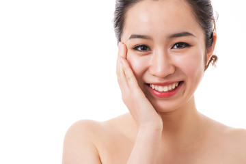 Beautiful face of young smiling woman with clean fresh skin. Touching face.