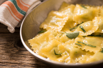 Italian cuisine: ravioli pasta with parmesan cheese and sage
