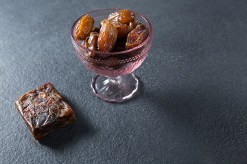 Dates fruits in glass bowl on slate