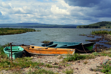 Old boats on the shore of the lake.