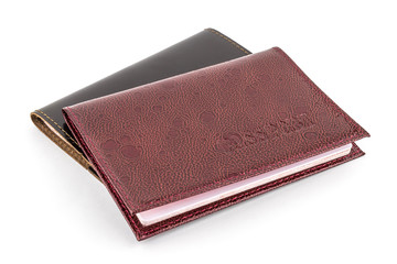 Two passports in leather covers on a white background close-up, isolated
