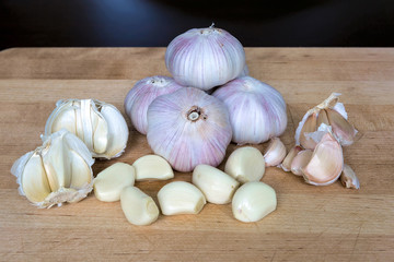 Whole and Peeled Garlic Cloves on Cutting Board