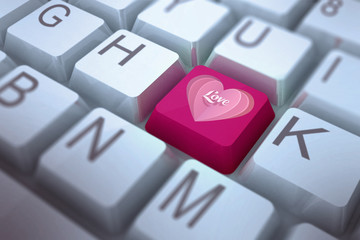 Love heart against pink key on keyboard