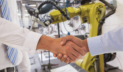 Close-up shot of a handshake in office against garage