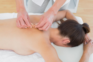 Fototapeta na wymiar Male physiotherapist massaging womans back