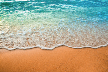 Fototapeta Wave of blue ocean on sandy beach. Background. obraz