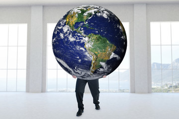 Businessman carrying the world against room overlooking ocean