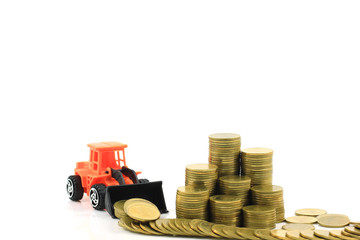 Stack of gold coins money and Truck toy on white background, Real estate investments and Finance loan concept.