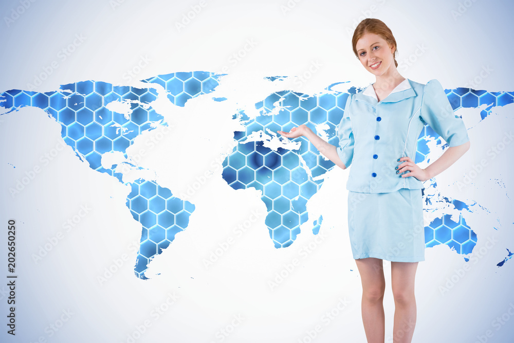 Poster pretty air hostess presenting with hand against background with hexagons and world map