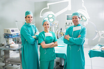 Surgeons with arms crossed smiling