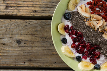 Healthy breakfast in bowl on wooden table