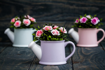 Obraz na płótnie Canvas Artificial Colorful Flowers in Decorative Flowerpots