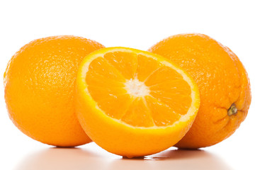 Oranges and slice of orange on white background