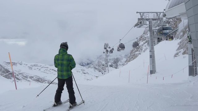People skiing and gondola lifts riding