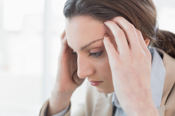 Close up side view of businesswoman suffering from headache