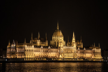Fototapeta na wymiar Hungarian Parliament (Orszaghaz) in Budapest, capital city of Hungary, taken during a dark night. The Parliament, of a gothic style, is the most iconic landmark of the city.