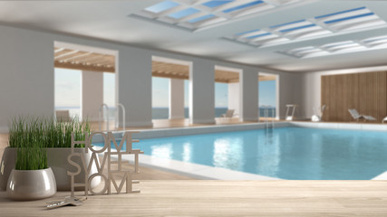Wooden table, desk or shelf with potted grass plant, house keys and 3D letters making the words home sweet home, over swimming pool, architecture interior design, copy space background