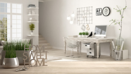 Wooden table, desk or shelf with potted grass plant, house keys and 3D letters making the words home sweet home, over home workplace, architecture interior design, copy space background