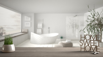 Wooden table, desk or shelf with potted grass plant, house keys and 3D letters making the words home sweet home, over minimalist bathroom, architecture interior design, copy space background