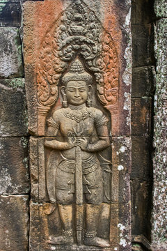 Khmer devata guardian shown in stone in Ta Prohm temple, in Angkor, Siem Reap, Cambodia.