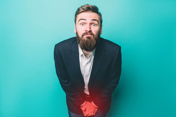 Guy is having problem with peeing. It is very painful for him. Isolated on blue background.