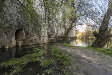 Scary and  dangerous wooden bridge over a river.