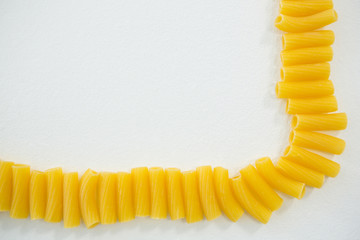 Sedani rigati pasta on arranged in a row