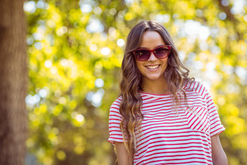 Pretty brunette smiling in the park