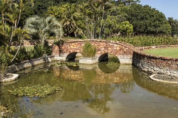 Fototapeta na wymiar landscape with bow bridge over a lake