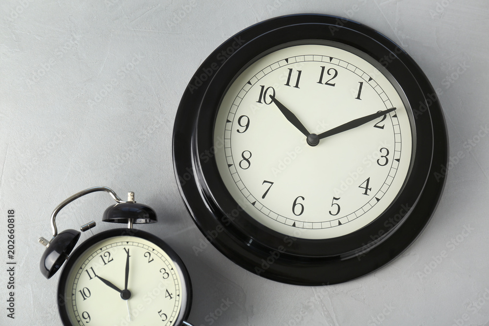 Poster different clocks on light background. time change concept