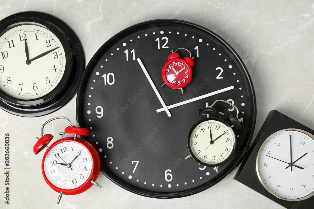 Poster many different clocks, top view. time change concept