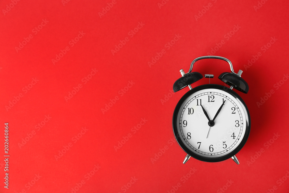 Poster Alarm clock on color background. Time change concept