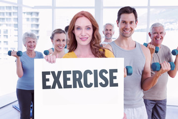 Pretty redhead showing a card against exercise